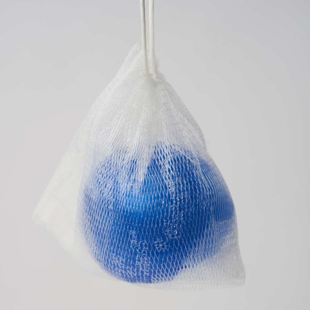 a blue ball of body soap inside a mesh bag