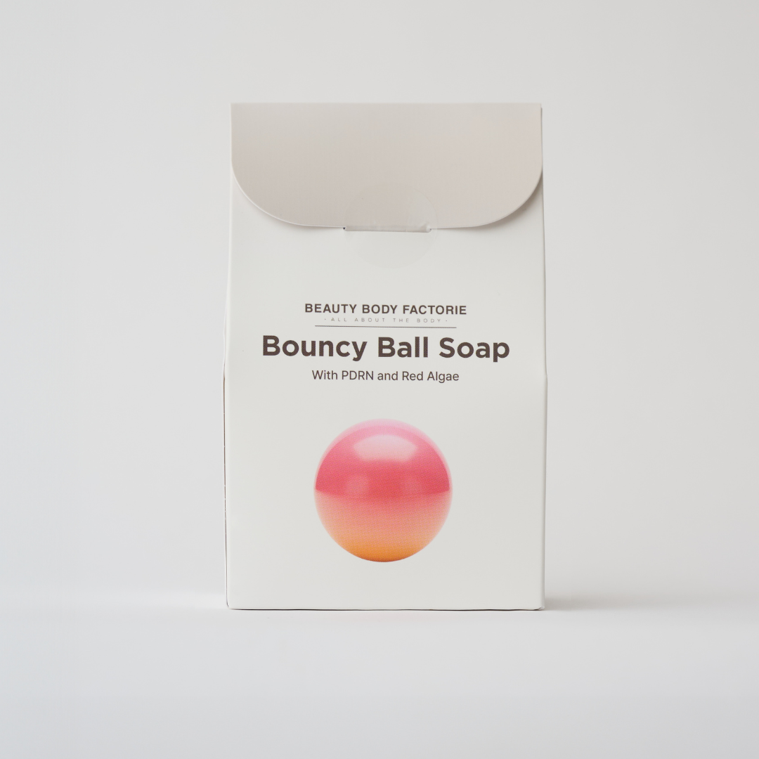 pink body soap in the shape of a ball in a box 