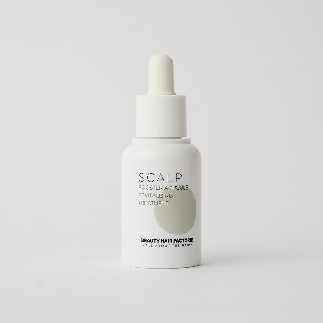white dropper bottle of scalp serum 