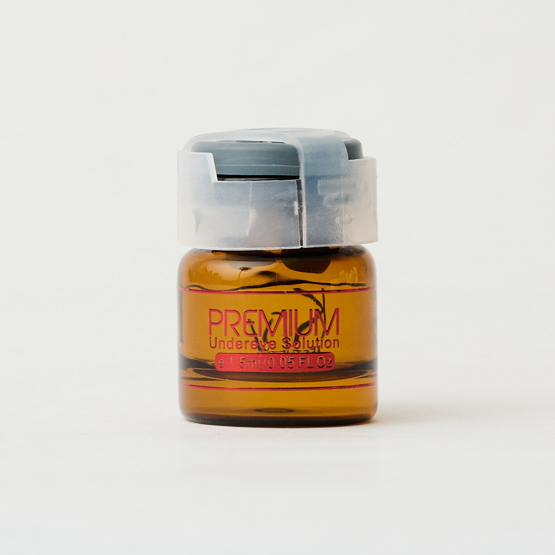 small amber glass container of under eye solution