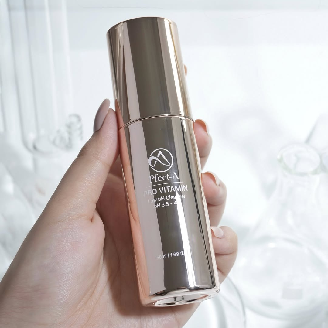 hand holding shiny skincare product 